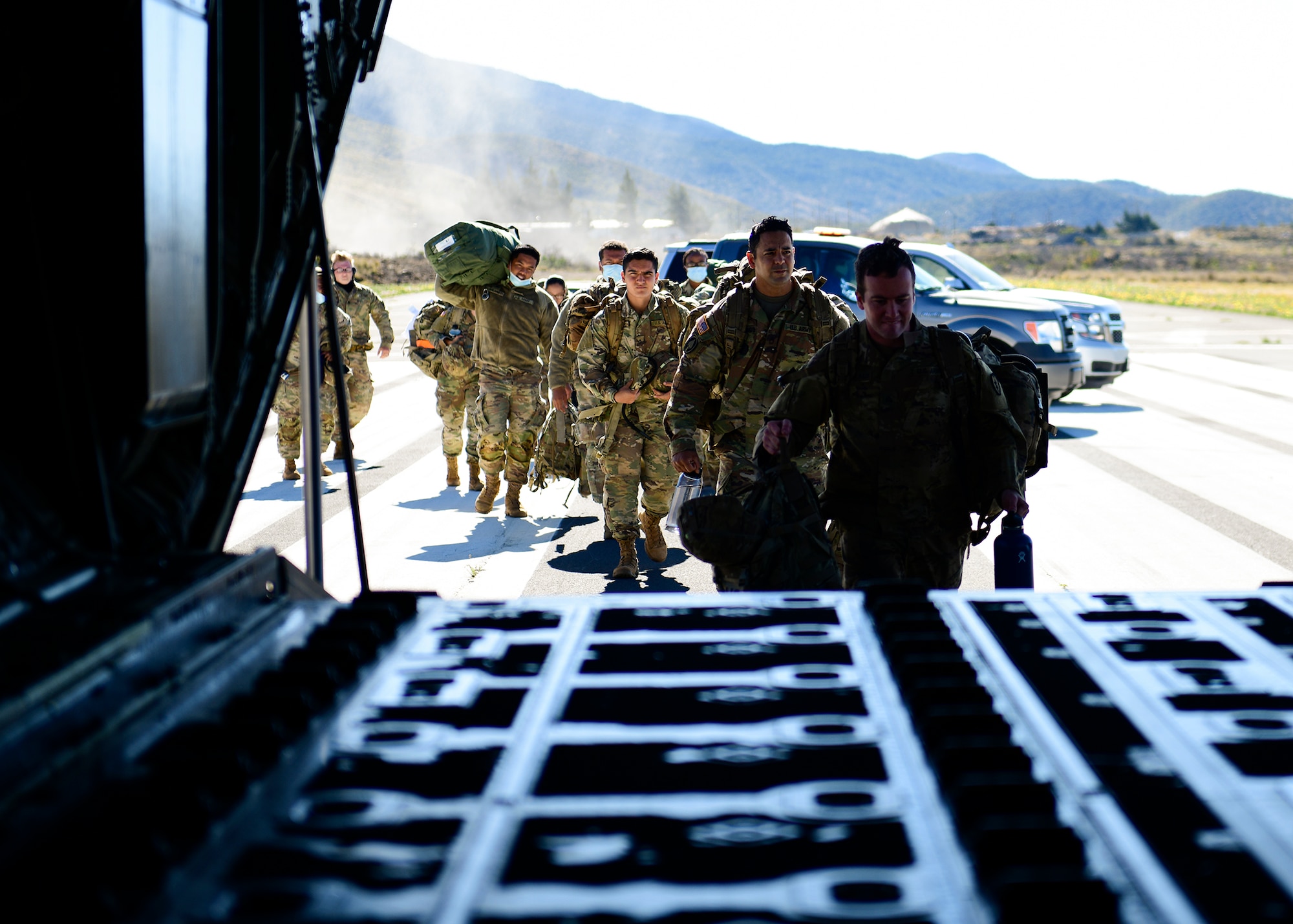 Soldiers board an aircraft.