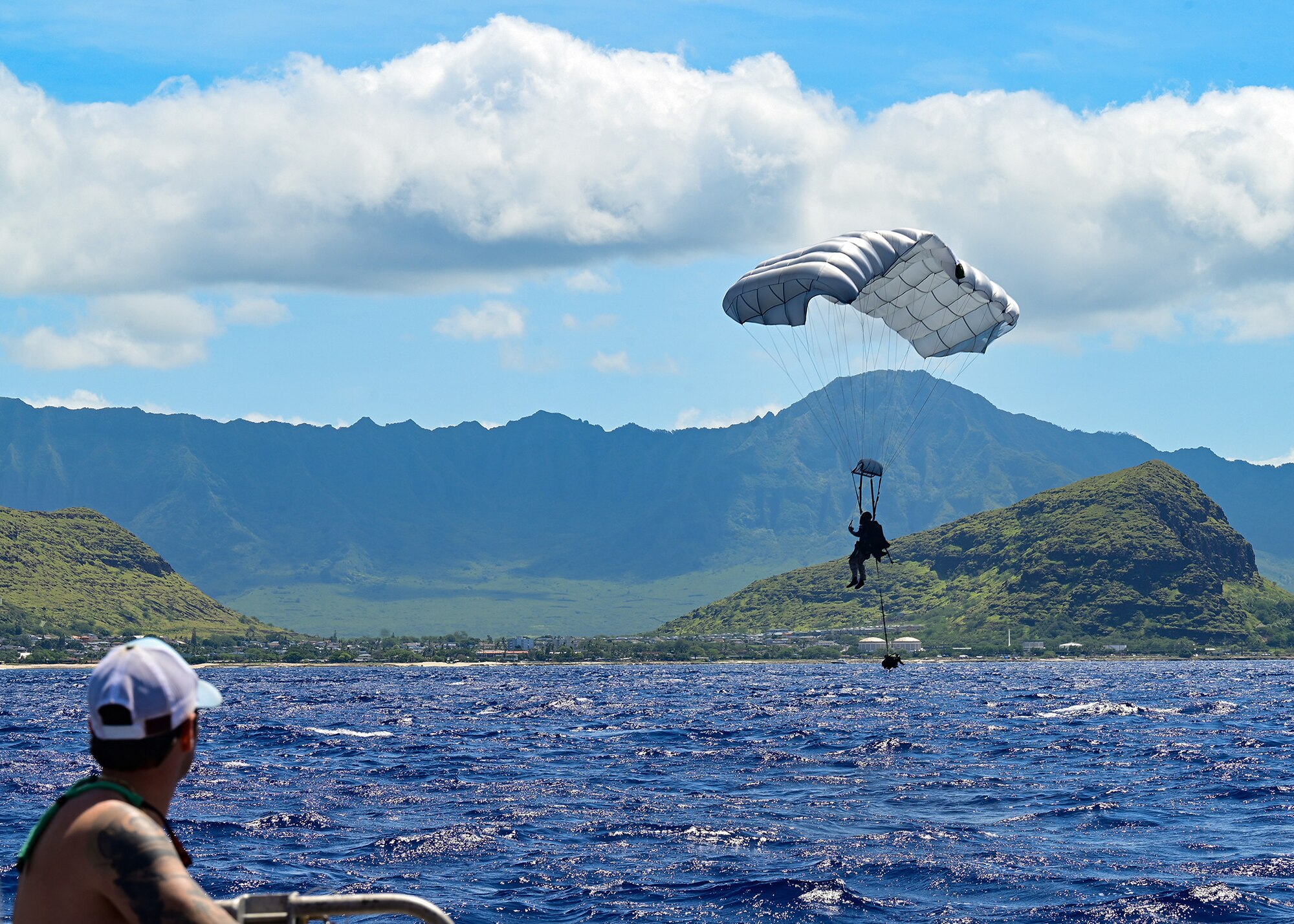 A Navy SEAL parachutes into the water