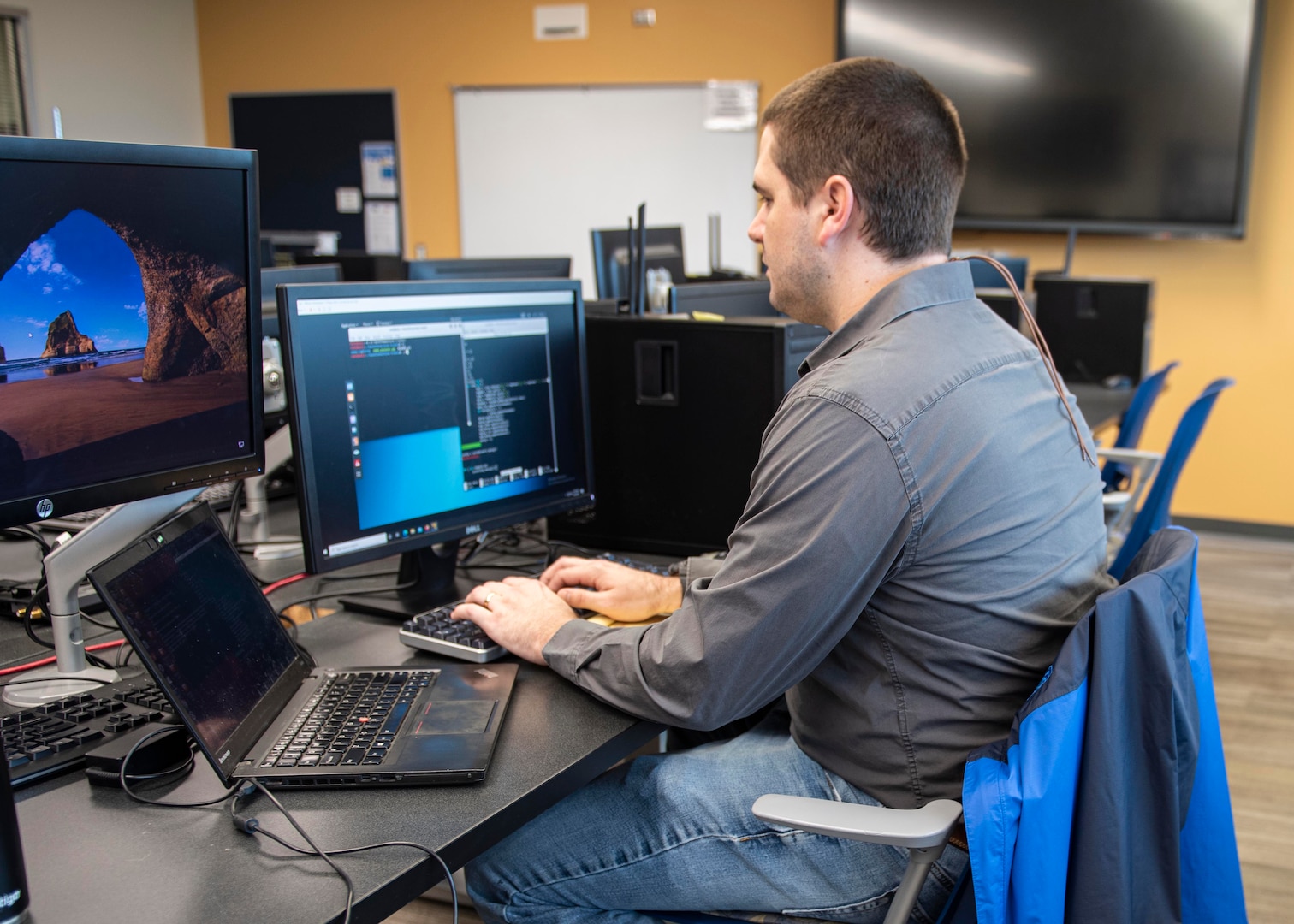 Joshua Davis, NSWC PCD engineer, develops python scripts to decode messages during the virtual 2021 HACKtheMACHINE challenge at Gulf Coast State College.