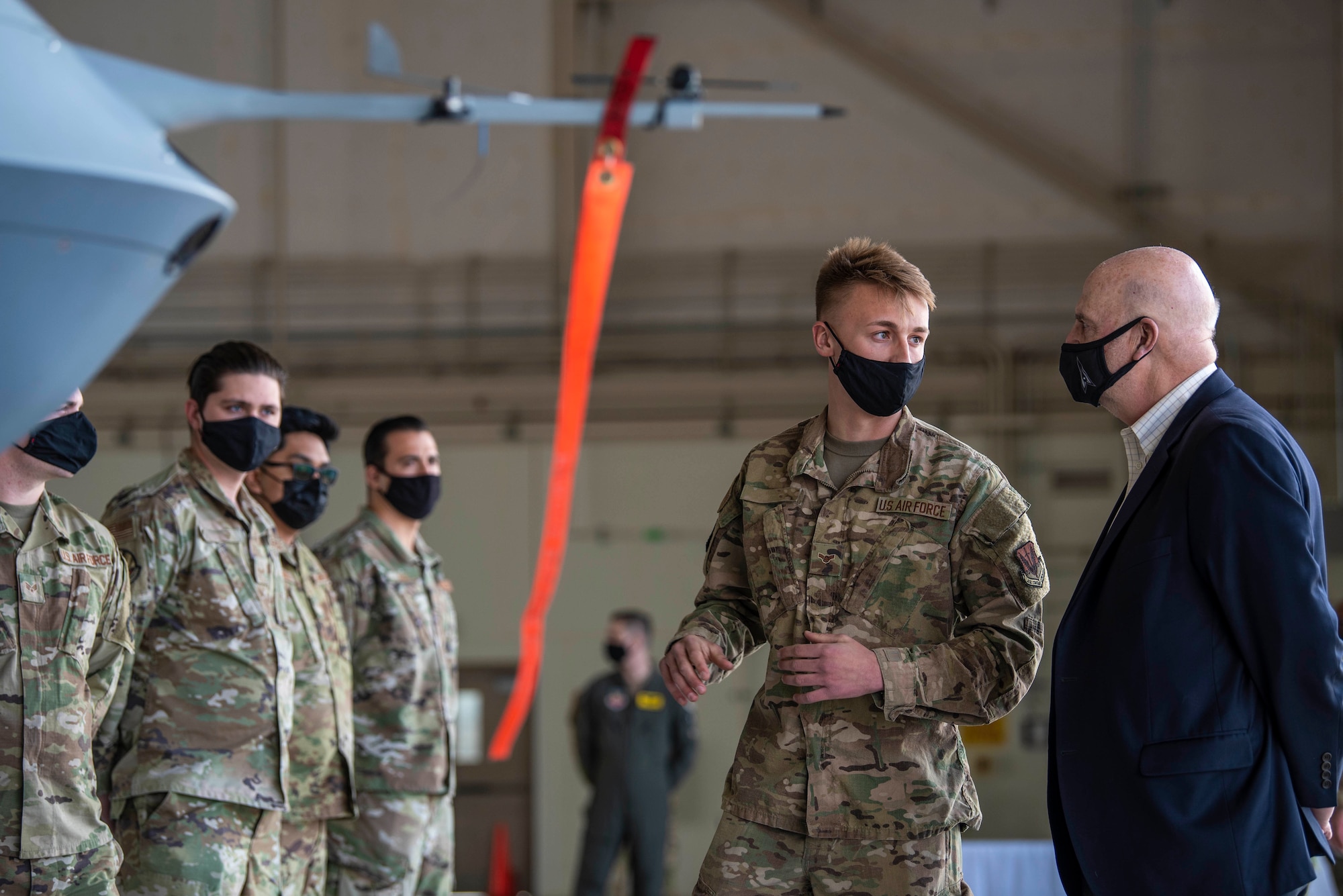 Acting Secretary of the Air Force John Roth, is briefed by a 432nd Maintenance Group Airman on the capabilities of the MQ-9 Reaper before meeting superior performers at Creech Air Force Base, Nev., March 25, 2021. Roth recognized Airmen from across the Wing, who are a testament to the array of specialties and talents needed to keep the U.S. ahead of the enemy. (U.S. Air Force photo by Senior Airman Haley Stevens)