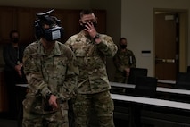 Man wearing virtual reality headset holds weapon