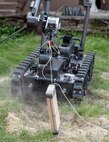 The Man Transportable Robotic System-Increment II, or MTSR II, removes a simulated pressure plate during training at Joint Base San Antonio-Lackland April 14.