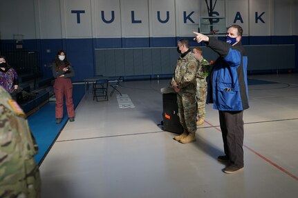 Members of the Alaska National Guard, along with members of the Alaska Department of Environmental Conservation, are introduced to the Tuluksak Tribal Council by Douglas Bushey, Principal of the Tuluksak School, Yupiit School District in Tuluksak, Alaska, April 8, 2021. Members of the Alaska Department of Military and Veterans Affairs, the Department of Environmental Conservation, and the Department of Commerce, Community, and Economic Development traveled to Western Alaska April 7-9 to meet with Tribal leaders and citizens in Bethel, Tuluksak, and Chevak to discuss disaster assistance measures and processes in light of recent emergencies that have occurred in the region, and in preparation for the upcoming flood season. (U.S. Army National Guard photo by Dana Rosso)