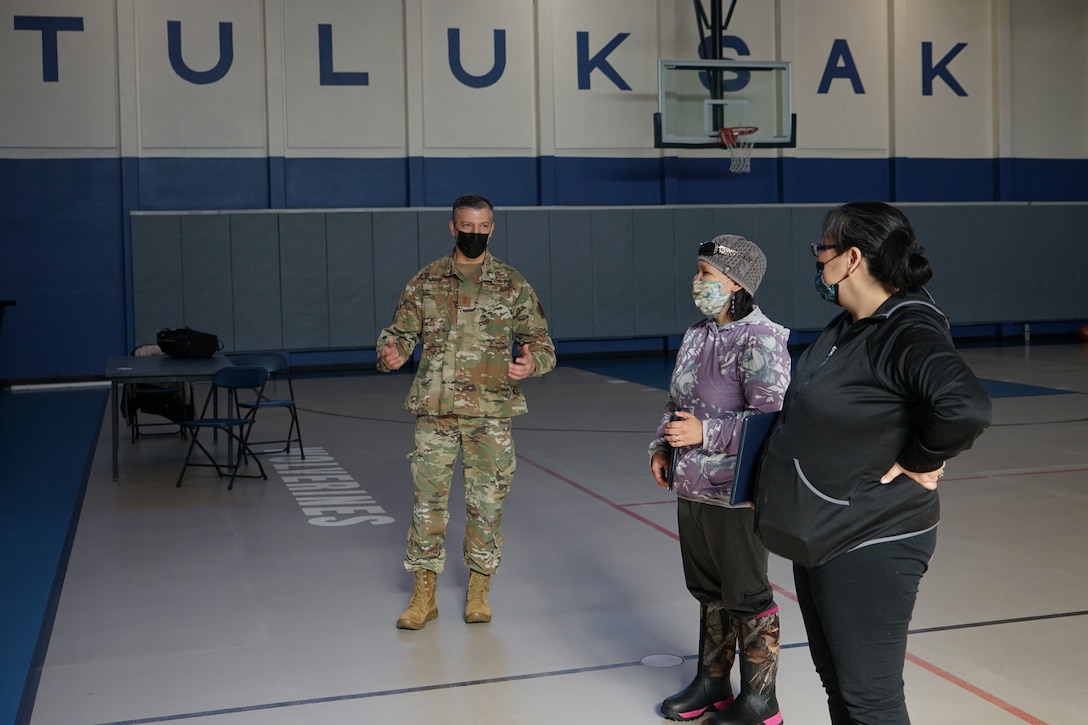 Maj. Gen. Torrence Saxe, commissioner for the Department of Military and Veterans Affairs and adjutant general of the Alaska National Guard, speaks to Kristy Napoka, Tribal Council secretary, treasurer, and utilities manager, and Elsie Allain, Tribal administrator, after presenting the State of Alaska Community Service Medal to each of them in Tuluksak, Alaska, April 8, 2021. Members of the Alaska Department of Military and Veterans Affairs, the Department of Environmental Conservation, and the Department of Commerce, Community, and Economic Development traveled to Western Alaska April 7-9 to meet with Tribal leaders and citizens in Bethel, Tuluksak, and Chevak to discuss disaster assistance measures and processes in light of recent emergencies that have occurred in the region, and in preparation for the upcoming flood season. (U.S. Army National Guard photo by Dana Rosso)