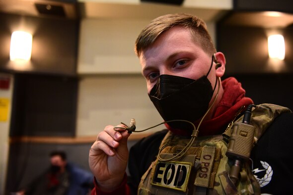Staff Sgt. Mark White, 8th Civil Engineer Squadron explosive ordnance disposal technician, poses for a photo with an inner ear bone conducting headset during a Wolf Tank at Kunsan Air Base, Republic of Korea, April 9, 2021. Wing leadership funded three of the five ideas that were presented, which included a wireless intercom system, an inner ear bone conducting headset, and hardened aircraft system GPS repeaters. (U.S. Air Force photo by Senior Airman Suzie Plotnikov)
