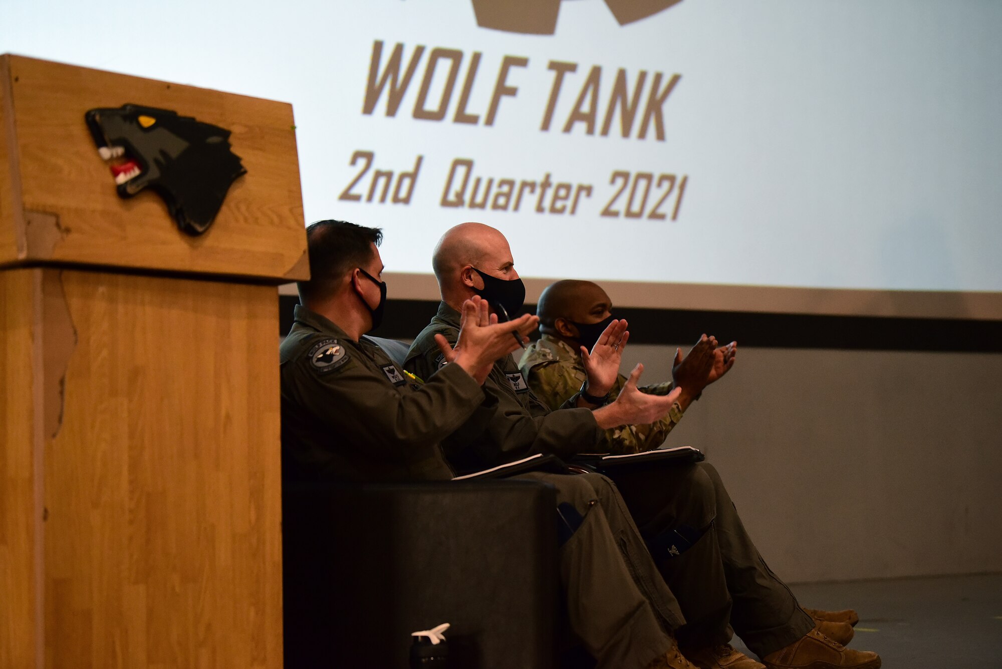 Wing leadership clap during a Wolf Tank introduction at Kunsan Air Base, Republic of Korea, April 9, 2021. Wing leadership funded three of the five ideas that were presented, which included a wireless intercom system, an inner ear bone conducting headset, and hardened aircraft system GPS repeaters. (U.S. Air Force photo by Senior Airman Suzie Plotnikov)