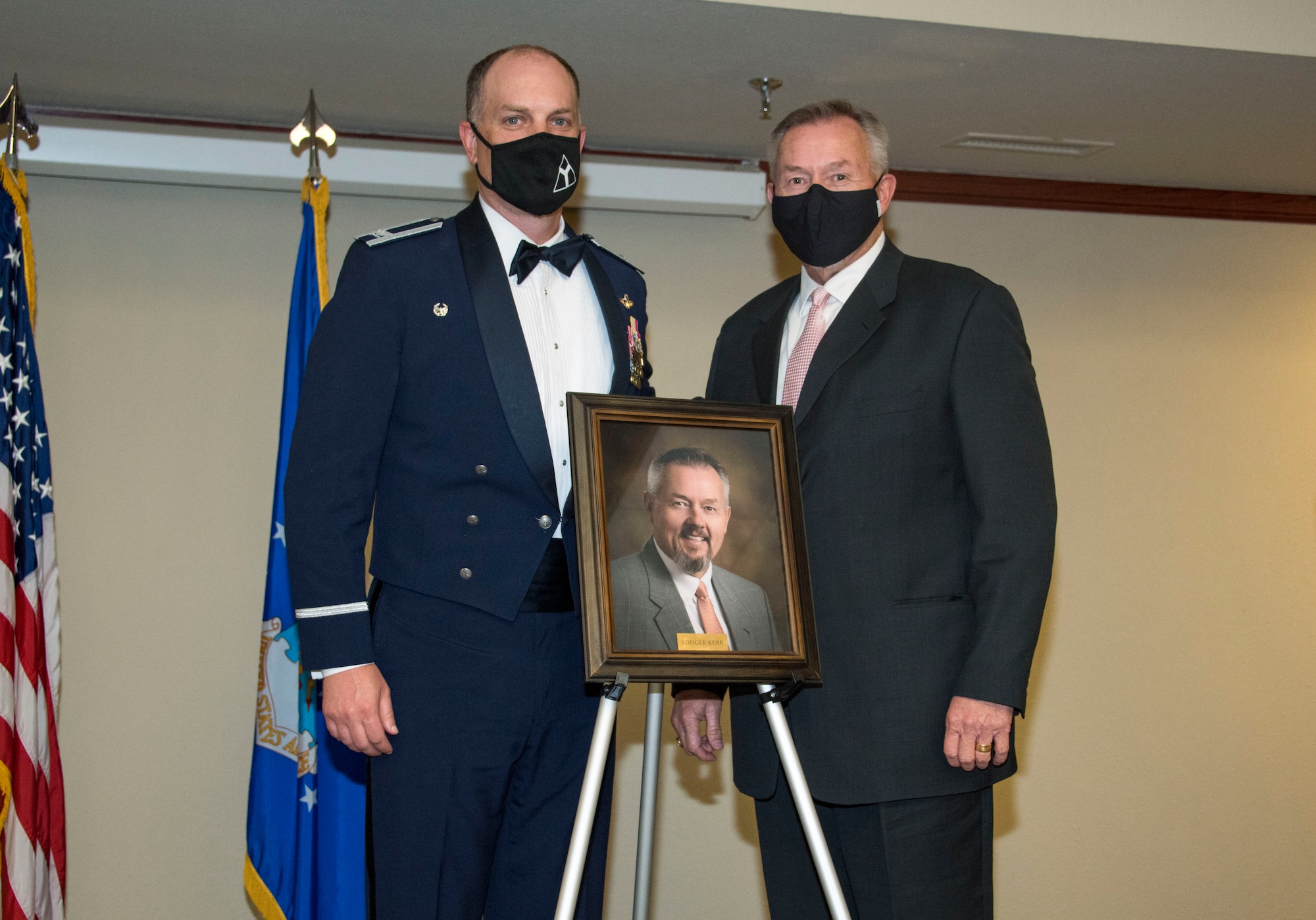 From left, Col. Matthew Leard, 97th Air Mobility Wing (AMW) commander, and Rodger Kerr, Altus Chamber of Commerce CEO and president, pose for a photo during a Friends of Altus induction ceremony on April 9, 2020, at Altus Air Force Base, Oklahoma. Kerr was one of two community leaders selected by Leard as a Friend of Altus, earning the highest honor a local civilian can receive from a 97th AMW commander. (U.S. Air Force photo by Airman 1st Class Amanda Lovelace)