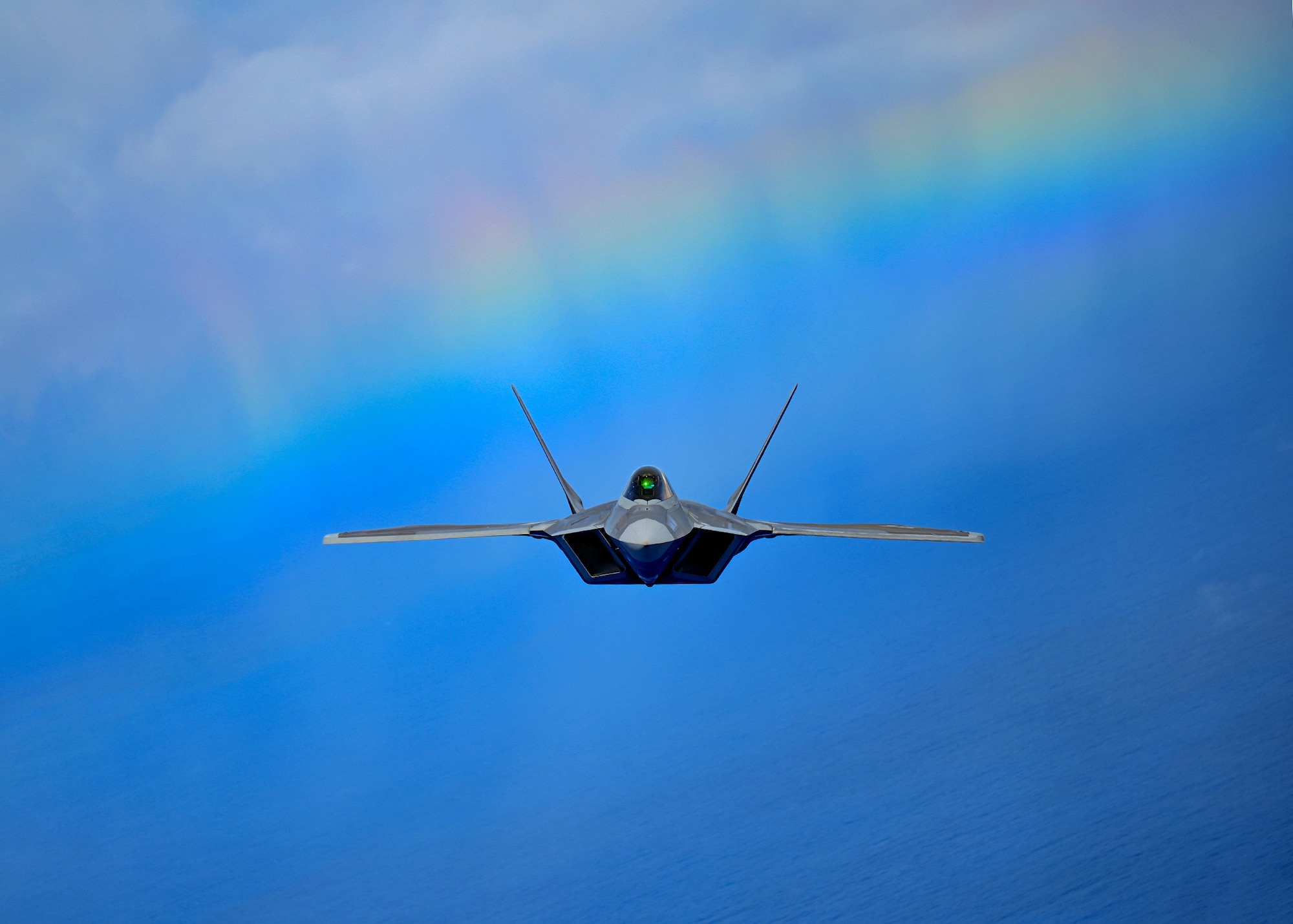 A fighter aircraft flies over Hawaii.