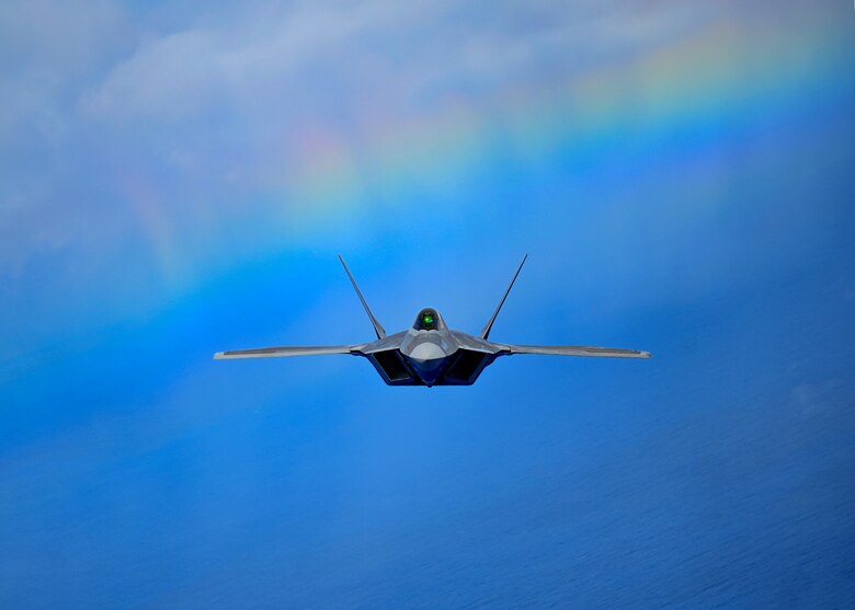 A fighter aircraft flies over Hawaii.