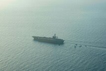 210413-N-MD713-2029 ARABIAN SEA (April 13, 2021) - U.S. Navy F/A-18F and F/A-18E Super Hornet fighter jets, an E-2C Hawkeye tactical airborne early warning aircraft and French Marine Nationale Dassault Rafale fighter jets fly in formation over the aircraft carrier USS Dwight D. Eisenhower (CVN 69), during dual carrier operations with the aircraft carrier FS Charles de Gaulle (R 91) in the Arabian Sea, April 13. The Eisenhower Carrier Strike Group is deployed to the U.S. 5th Fleet area of operations in support of naval operations to ensure maritime stability and security in the Central Region, connecting the Mediterranean and Pacific through the western Indian Ocean and three strategic choke points. (U.S. Navy photo by Mass Communication Specialist 3rd Class Cameron Pinske)