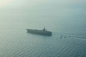210413-N-MD713-2029 ARABIAN SEA (April 13, 2021) - U.S. Navy F/A-18F and F/A-18E Super Hornet fighter jets, an E-2C Hawkeye tactical airborne early warning aircraft and French Marine Nationale Dassault Rafale fighter jets fly in formation over the aircraft carrier USS Dwight D. Eisenhower (CVN 69), during dual carrier operations with the aircraft carrier FS Charles de Gaulle (R 91) in the Arabian Sea, April 13. The Eisenhower Carrier Strike Group is deployed to the U.S. 5th Fleet area of operations in support of naval operations to ensure maritime stability and security in the Central Region, connecting the Mediterranean and Pacific through the western Indian Ocean and three strategic choke points. (U.S. Navy photo by Mass Communication Specialist 3rd Class Cameron Pinske)