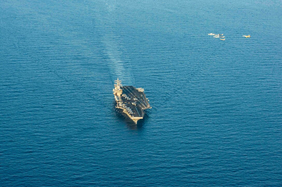 210413-N-MD713-2057 ARABIAN SEA (April 13, 2021) - U.S. Navy F/A-18F and F/A-18E Super Hornet fighter jets, an E-2C Hawkeye tactical airborne early warning aircraft and French Marine Nationale Dassault Rafale fighter jets fly in formation over the aircraft carrier USS Dwight D. Eisenhower (CVN 69), during dual carrier operations with the aircraft carrier FS Charles de Gaulle (R 91) in the Arabian Sea, April 13. The Eisenhower Carrier Strike Group is deployed to the U.S. 5th Fleet area of operations in support of naval operations to ensure maritime stability and security in the Central Region, connecting the Mediterranean and Pacific through the western Indian Ocean and three strategic choke points. (U.S. Navy photo by Mass Communication Specialist 3rd Class Cameron Pinske)