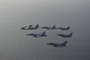 210413-N-NO712-1115 ARABIAN SEA (April 13, 2021) - U.S. Navy F/A-18F and F/A-18E Super Hornet fighter jets, an E-2C Hawkeye tactical airborne early warning aircraft and French Marine Nationale Dassault Rafale fighter jets fly in formation during dual carrier operations between the aircraft carriers USS Dwight D. Eisenhower (CVN 69) and FS Charles de Gaulle (R 91) in the Arabian Sea, April 13. The Eisenhower Carrier Strike Group is deployed to the U.S. 5th Fleet area of operations in support of naval operations to ensure maritime stability and security in the Central Region, connecting the Mediterranean and Pacific through the western Indian Ocean and three strategic choke points. (U.S. Navy Photo)