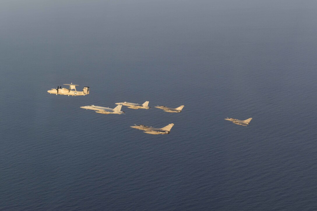210413-N-NO712-1235 ARABIAN SEA (April 13, 2021) - U.S. Navy F/A-18F and F/A-18E Super Hornet fighter jets, an E-2C Hawkeye tactical airborne early warning aircraft and French Marine Nationale Dassault Rafale fighter jets fly in formation during dual carrier operations between the aircraft carriers USS Dwight D. Eisenhower (CVN 69) and FS Charles de Gaulle (R 91) in the Arabian Sea, April 13. The Eisenhower Carrier Strike Group is deployed to the U.S. 5th Fleet area of operations in support of naval operations to ensure maritime stability and security in the Central Region, connecting the Mediterranean and Pacific through the western Indian Ocean and three strategic choke points. (U.S. Navy Photo)