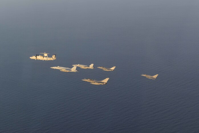 210413-N-NO712-1235 ARABIAN SEA (April 13, 2021) - U.S. Navy F/A-18F and F/A-18E Super Hornet fighter jets, an E-2C Hawkeye tactical airborne early warning aircraft and French Marine Nationale Dassault Rafale fighter jets fly in formation during dual carrier operations between the aircraft carriers USS Dwight D. Eisenhower (CVN 69) and FS Charles de Gaulle (R 91) in the Arabian Sea, April 13. The Eisenhower Carrier Strike Group is deployed to the U.S. 5th Fleet area of operations in support of naval operations to ensure maritime stability and security in the Central Region, connecting the Mediterranean and Pacific through the western Indian Ocean and three strategic choke points. (U.S. Navy Photo)