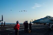 210413-N-OB471-1005 ARABIAN SEA (April 13, 2021) - U.S. Navy F/A-18F and F/A-18E Super Hornet fighter jets, an E-2C Hawkeye tactical airborne early warning aircraft and French Marine Nationale Dassault Rafale fighter jets fly in formation over the aircraft carrier USS Dwight D. Eisenhower (CVN 69), during dual carrier operations with the aircraft carrier FS Charles de Gaulle (R 91) in the Arabian Sea, April 13.  The Eisenhower Carrier Strike Group is deployed to the U.S. 5th Fleet area of operations in support of naval operations to ensure maritime stability and security in the Central Region, connecting the Mediterranean and Pacific through the western Indian Ocean and three strategic choke points. (U.S. Navy photo by Mass Communication Specialist Seaman Jacob Hilgendorf)