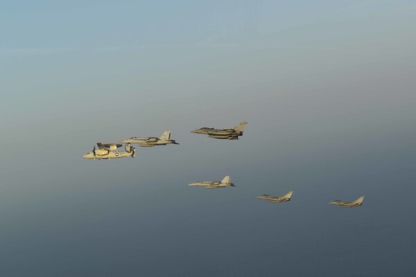 U.S. Navy and French navy aircraft fly in formation during dual carrier operations between USS Dwight D. Eisenhower (CVN 69) and FS Charles de Gaulle (R 91) in the Arabian Sea.