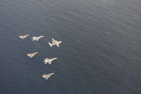 U.S. Navy and French navy aircraft fly in formation during dual carrier operations between USS Dwight D. Eisenhower (CVN 69) and FS Charles de Gaulle (R 91) in the Arabian Sea.