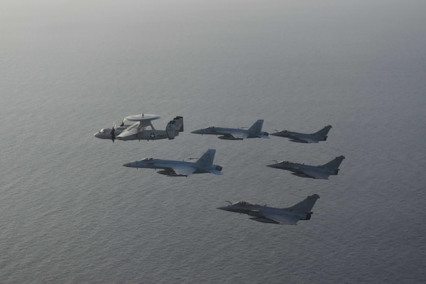 210413-N-NO712-1115 ARABIAN SEA (April 13, 2021) - U.S. Navy F/A-18F and F/A-18E Super Hornet fighter jets, an E-2C Hawkeye tactical airborne early warning aircraft and French Marine Nationale Dassault Rafale fighter jets fly in formation during dual carrier operations between the aircraft carriers USS Dwight D. Eisenhower (CVN 69) and FS Charles de Gaulle (R 91) in the Arabian Sea, April 13. The Eisenhower Carrier Strike Group is deployed to the U.S. 5th Fleet area of operations in support of naval operations to ensure maritime stability and security in the Central Region, connecting the Mediterranean and Pacific through the western Indian Ocean and three strategic choke points. (U.S. Navy Photo)