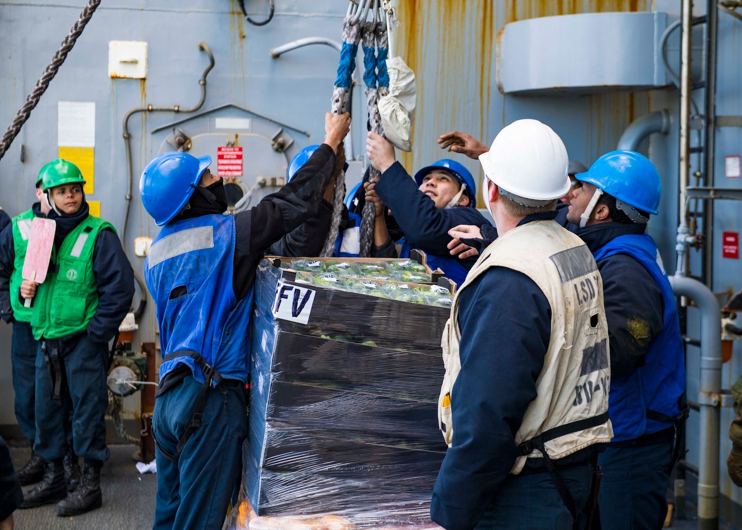 Sailors assigned to the Harpers Ferry-class dock landing ship USS Carter Hall (LSD 50) receive supplies from the fast combat support ship USNS Supply (T-AOE 6) during a replenishment-at-sea, April 12, 2021.