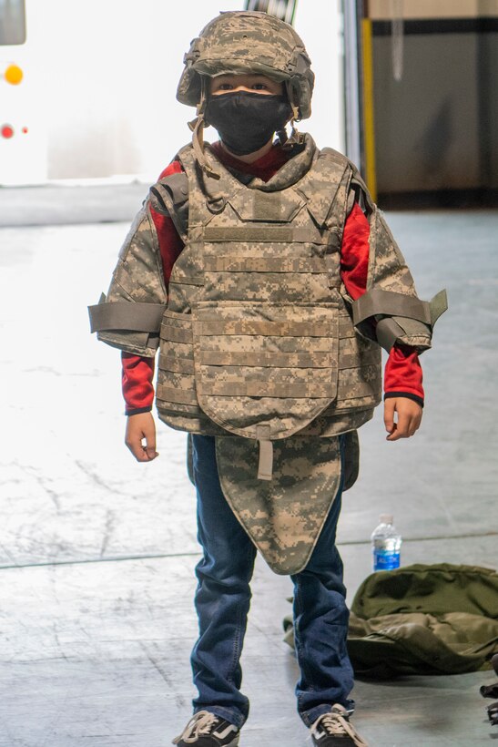 A child at the 4th Logistics Readiness Squadron Kids Day event wears a bulletproof vest at Seymour Johnson Air Force Base, North Carolina, March 24, 2021.