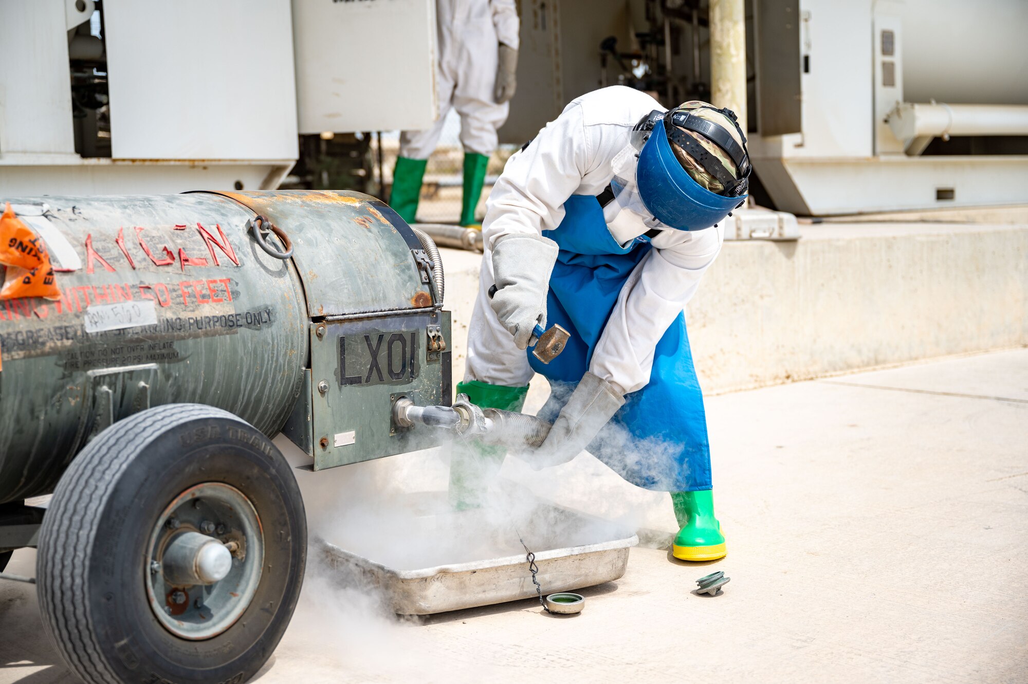 Senior Airman Steven C. Rehana opens a valve to release liquid oxygen.