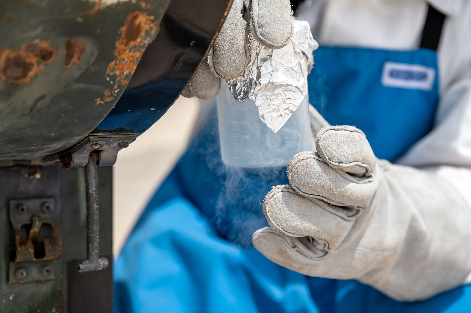 Senior Airman Steven C. Rehana collects a liquid oxygen sample.