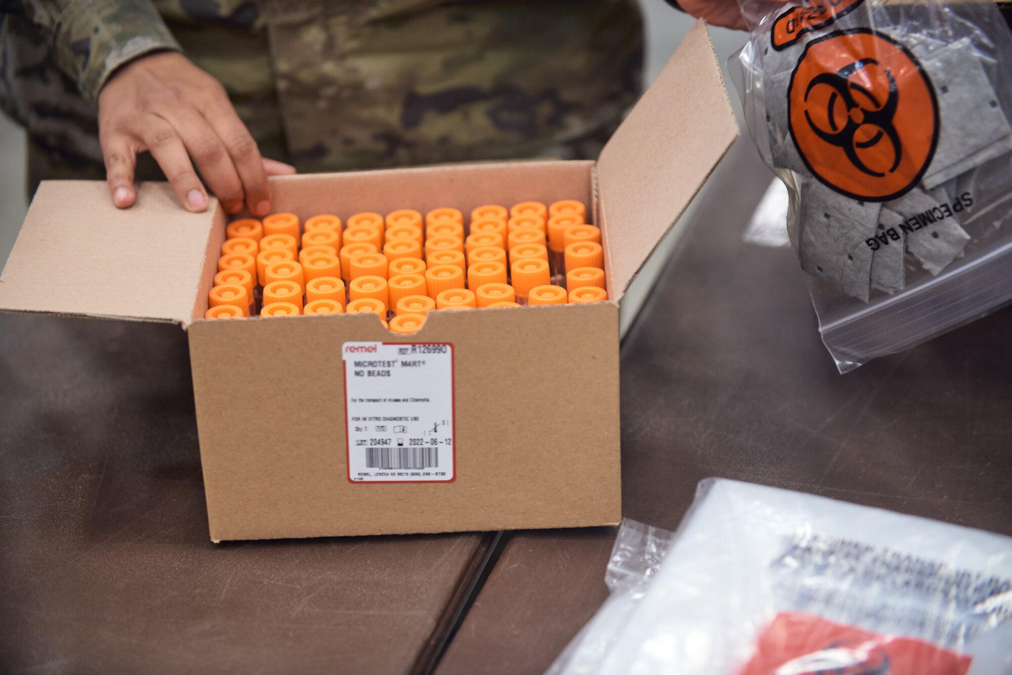 Army Spc. Claude Hamilton, a construction engineer assigned to the 1156th Engineer Company, Sgt. Luis Rodriguez, a chemical sergeant assigned to the 1156th and Pfc. Sydney Smith, a MP assigned to the 206th Military Police Company, quality control check COVID-19 test kits to be shipped across New York state, Hudson Valley Community College, Troy, N.Y., April 13, 2021. The test kits are being mass produced, with each box containing numerous of each item required to conduct a COVID-19 test, allowing the Guard to produce 10 million test kits in a year. (U.S. Army National Guard photo by Ryan Campbell)