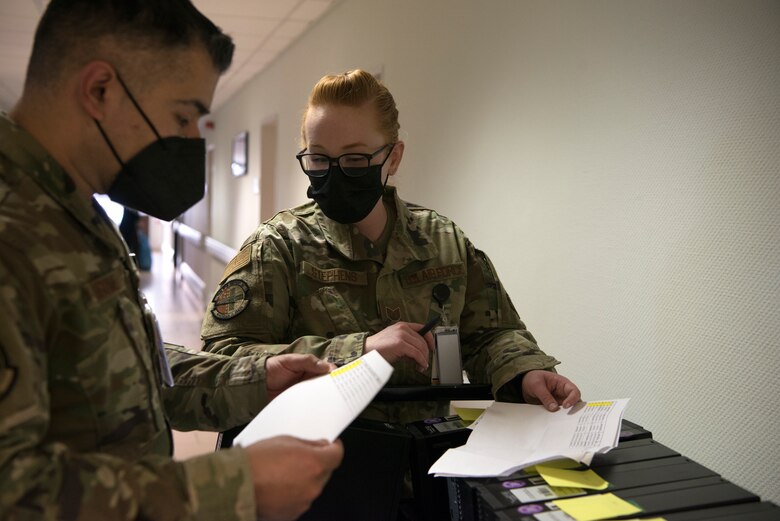 U.S. Air Force Master Sgt. Jose Gomez Miranda, 86th Medical Support Squadron medical information services flight chief, left, and Tech. Sgt. Kaci Stephens, 86th MDSS medical information services flight client support noncommissioned officer in charge, review the inventory of computer stations for the dental clinic at Ramstein Air Base, Germany, April 6, 2021.