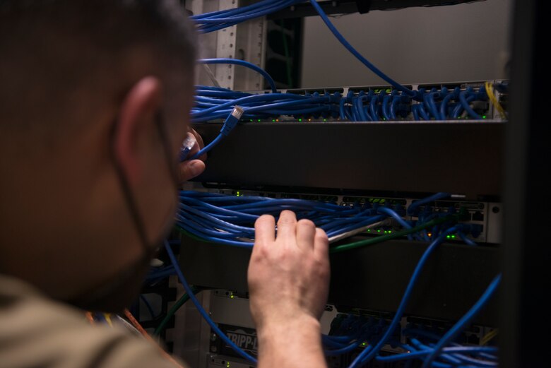 U.S. Air Force Master Sgt. Jose Gomez Miranda, 86th Medical Support Squadron medical information services flight chief, activates ports on the patch panel within the dental clinic at Ramstein Air Base, Germany, April 6, 2021.