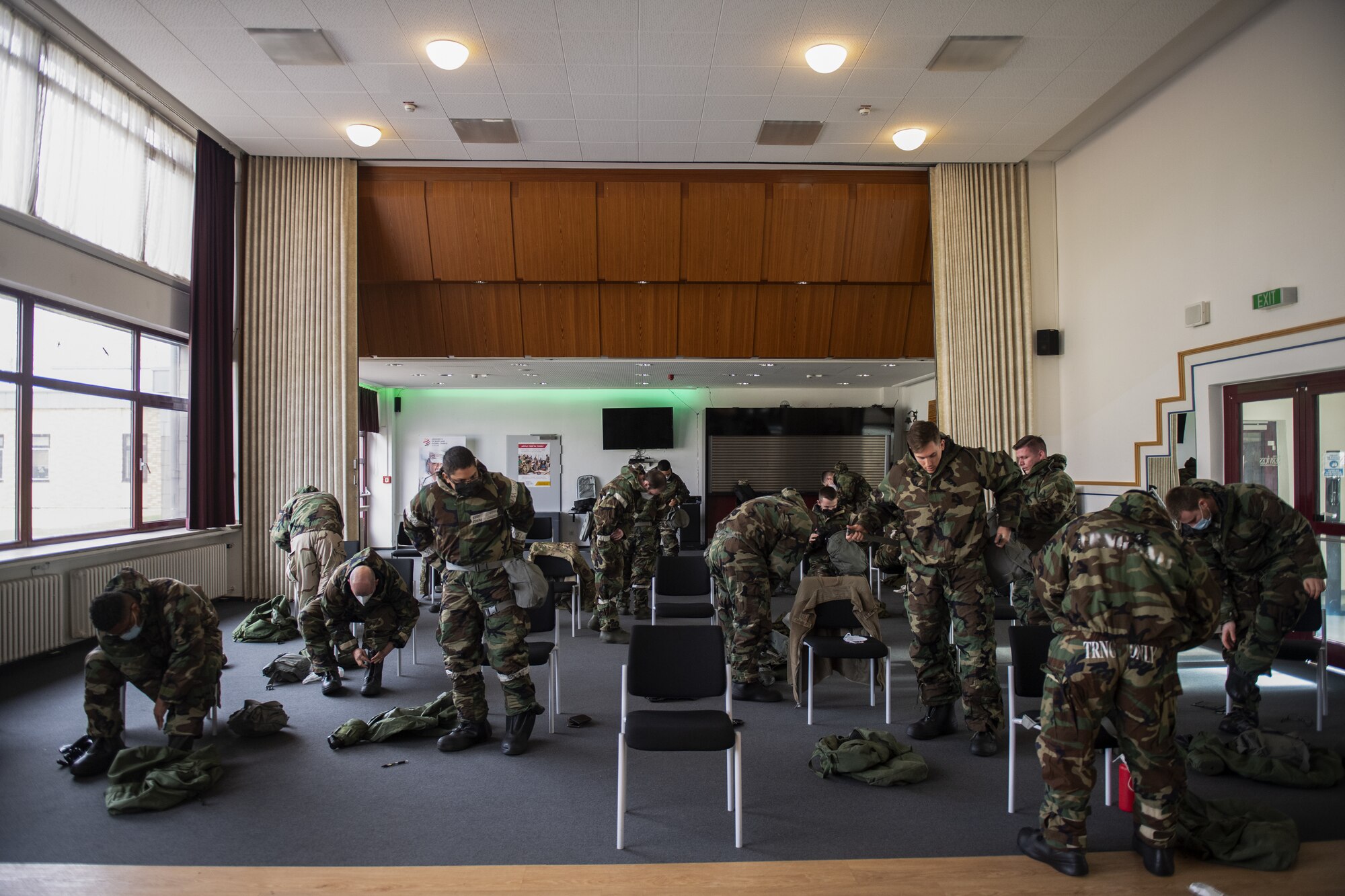U.S. Air Force Airmen from the 702nd Munitions Support Squadron don their Mission Oriented Protective Posture gear during a chemical, biological, radiological and nuclear response training course at the 702nd MUNSS, April 13, 2021. Donning MOPP gear is an essential part of the course and must be done within a specific time frame to ensure members are protected from any potential CBRN attacks. (U.S. Air Force photo by Senior Airman Ali Stewart)