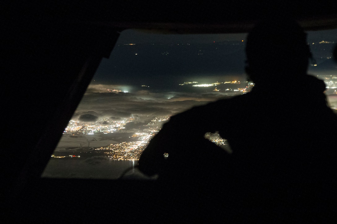 U.S. Marine Corps Cpl. Ethan Sproul, an MV-22B Osprey crew chief, assigned to Marine Aviation Weapons and Tactics Squadron One, observes landscapes to maintain situational awareness, during a night tactics exercise in support of Weapons and Tactics Instructor course 2-21, near Yuma, Ariz., April 5, 2021. The WTI course is a seven-week training event hosted by MAWTS-1, providing standardized advanced tactical training and certification of unit instructor qualifications to support Marine aviation training and readiness, and assists in developing and employing aviation weapons and tactics.