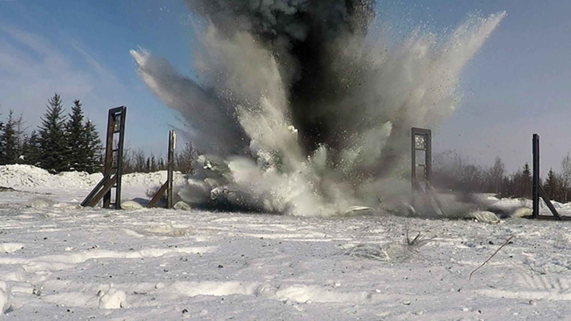 U.S. Air Force Airmen from the 354th Civil Engineer Squadron Explosive Ordnance Disposal (EOD) flight, the Iceman Spark Innovation team, Air Force Reach Laboratory innovation team, and other partners set off an explosion for the EOD snow mitigation test on March 18, 2021, at Eielson Air Force Base, Alaska. The experiment tested the use of snow to mitigate the damaging effects of explosions in an arctic environment. (U.S. Air Force photo/Senior Airman Danielle Sukhlall)