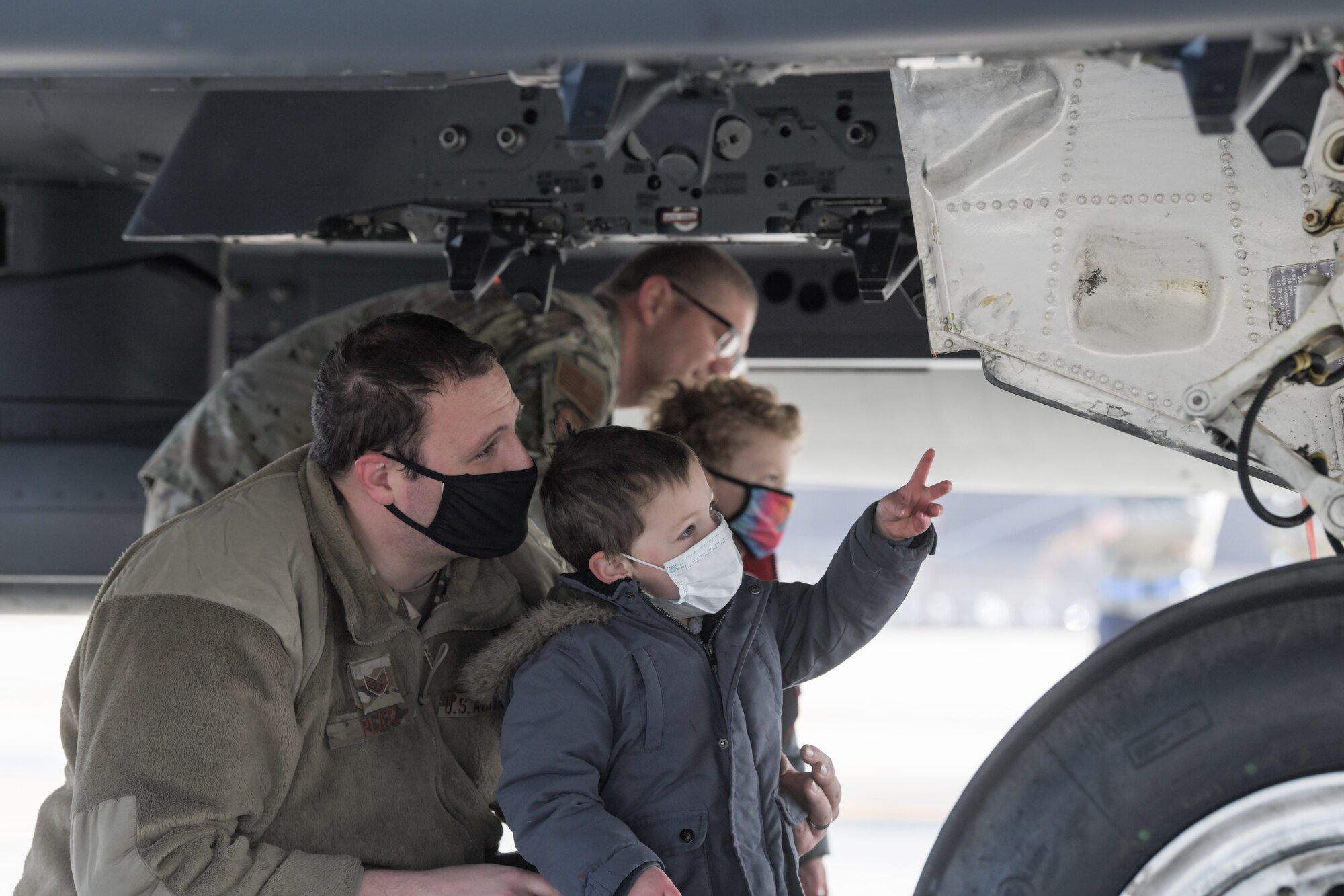 An Airman assigned to the 48th Fighter Wing shows his son around an F-15E Strike Eagle during a tour supporting the Month of the Military Child on April 15, 2021, at Royal Air force Lakenheath, England. Approximately 2 million military children have experienced a parental deployment since 9/11. (U.S. Air Force photo by Senior Airman Shanice Ship)