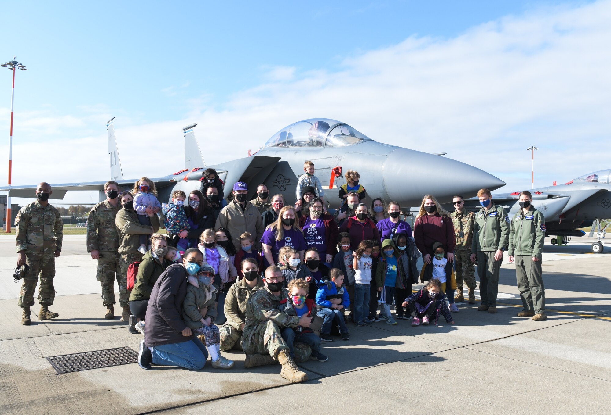 48th Fighter Wing personnel and military-affiliated children pose for a group photo on the flightline in support of the Month of the Military Child on April 15, 2021, at Royal Air Force Lakenheath, England. The Month of the Military Child highlights the experience of the dependent children of military members serving at home and overseas. (U.S. Air Force photo by Senior Airman Shanice Ship)
