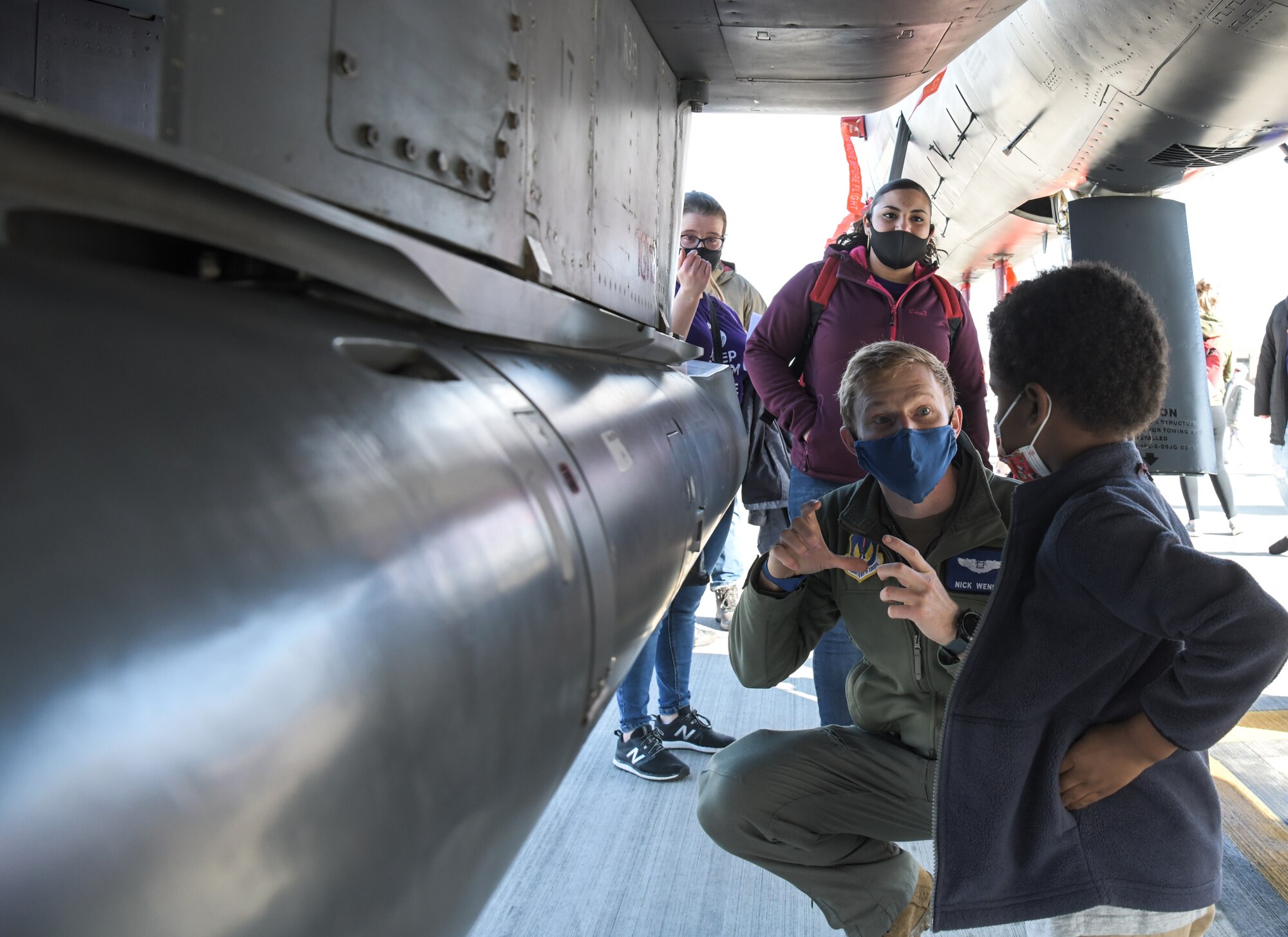 An Aircrew member assigned to the 492nd Fighter Squadron shows a child around an F-15E Strike Eagle during a tour supporting the Month of the Military Child on April 15, 2021, at Royal Air force Lakenheath, England. The tour was part of the Month of the Military child initiative, which stresses the importance of providing children with quality services and support to help them succeed in the mobile military lifestyle. (U.S. Air Force photo by Senior Airman Shanice Ship)