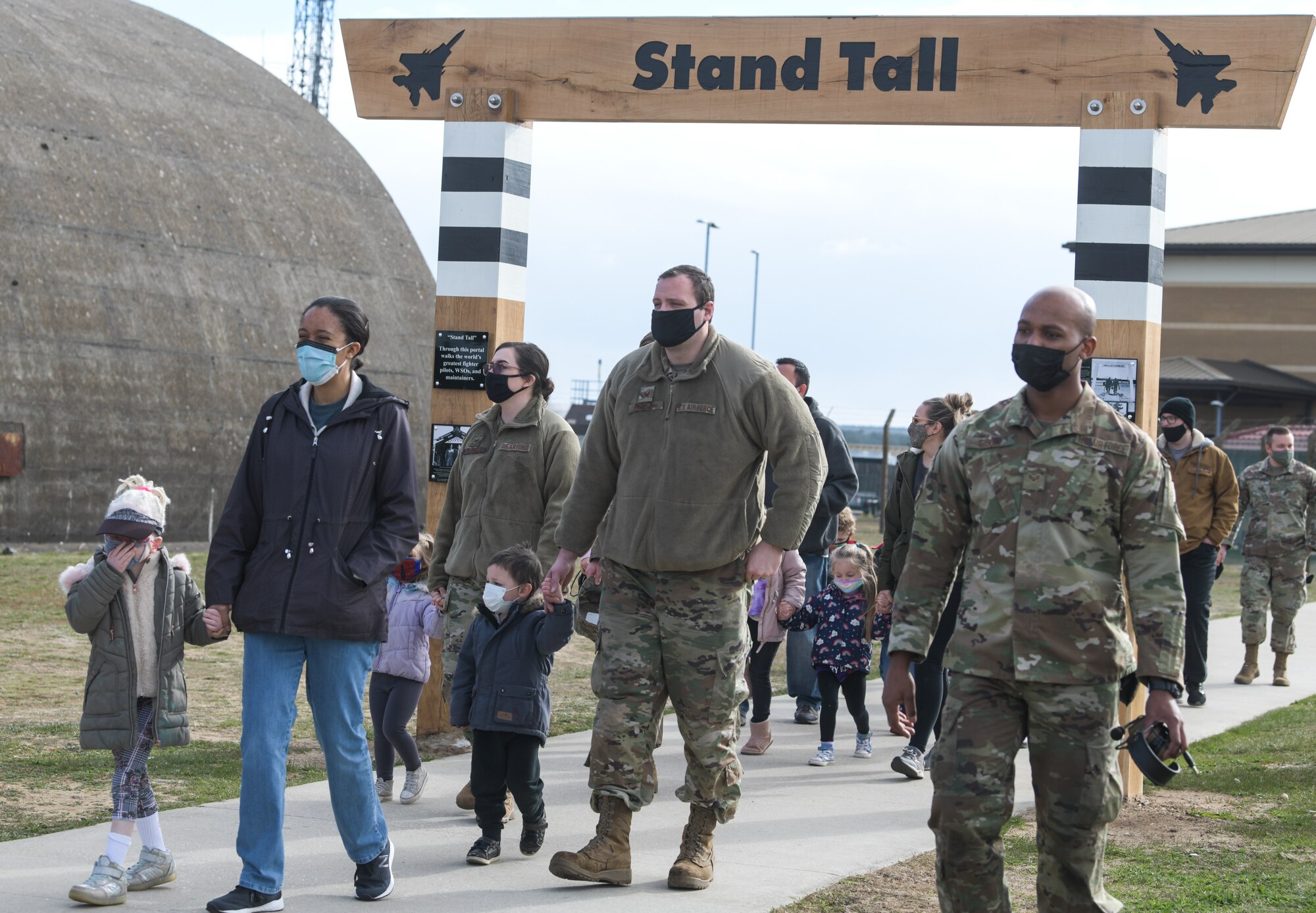 Military families escort their children onto the flightline for a tour on April 15, 2021, at Royal Air Force Lakenheath, England. April, designated Month of the Military Child, highlights the experience of the dependent children of military members serving at home and overseas. (U.S. Air Force photo by Senior Airman Shanice Ship)