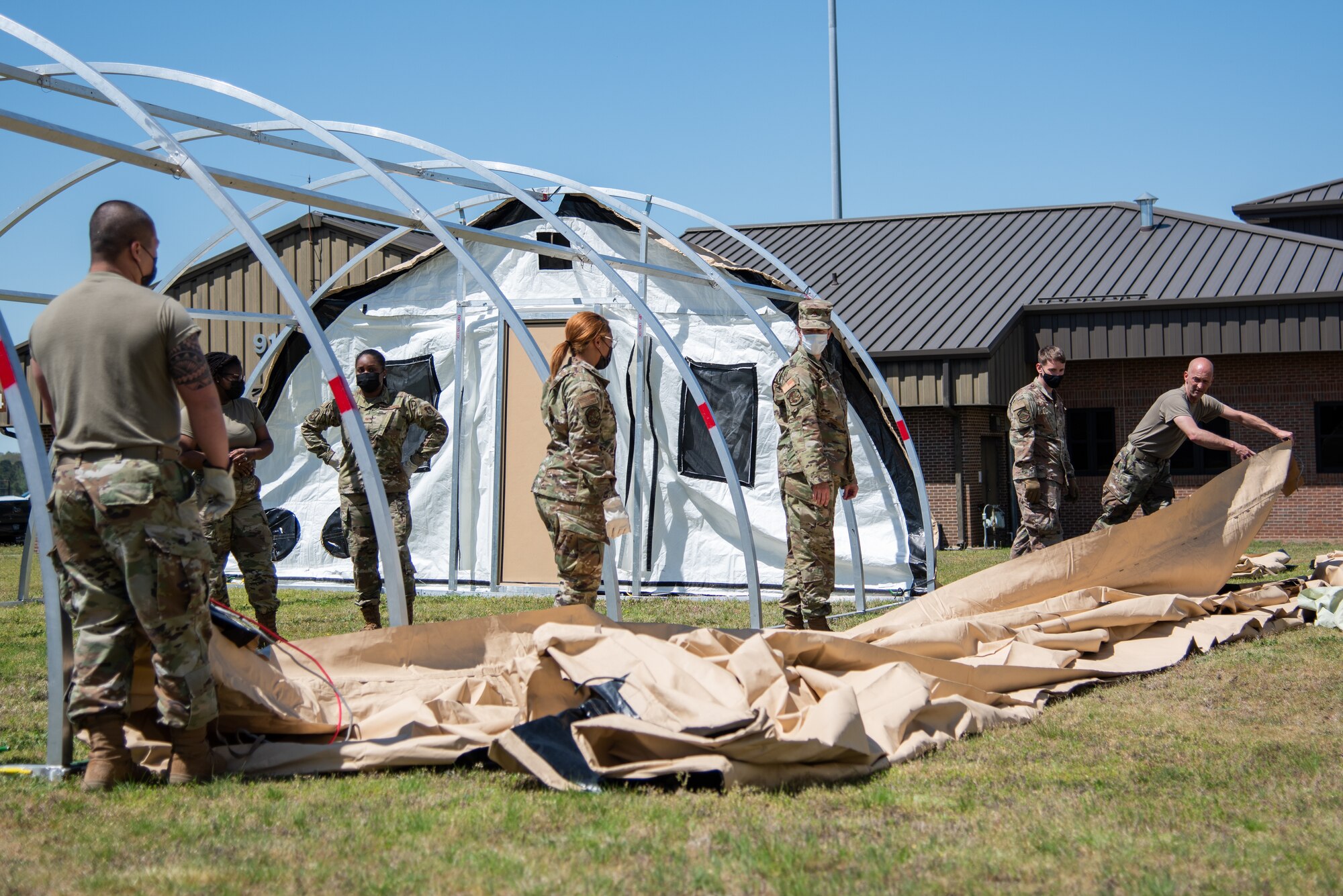 Reserve Citizen Airmen of the 913th Force Support Squadron organize the canvas material to build up an Alaska tent during the 4-day unit training assembly, April 8, 2021, a Little Rock Air Force Base, Arkansas. The tent is commonly used during deployments and the training was one of many sessions that took place to ensure personnel are ready to deploy and operate in dynamic, austere environments. (U.S. Air Force photo by Senior Airman Kalee Sexton)