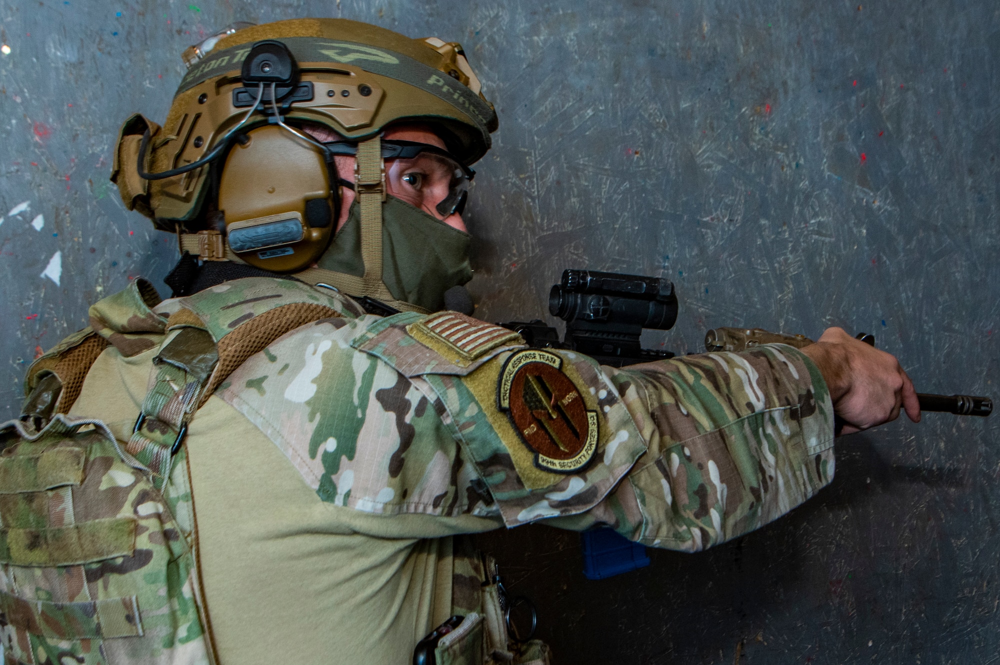 Airman points a rifle during training.