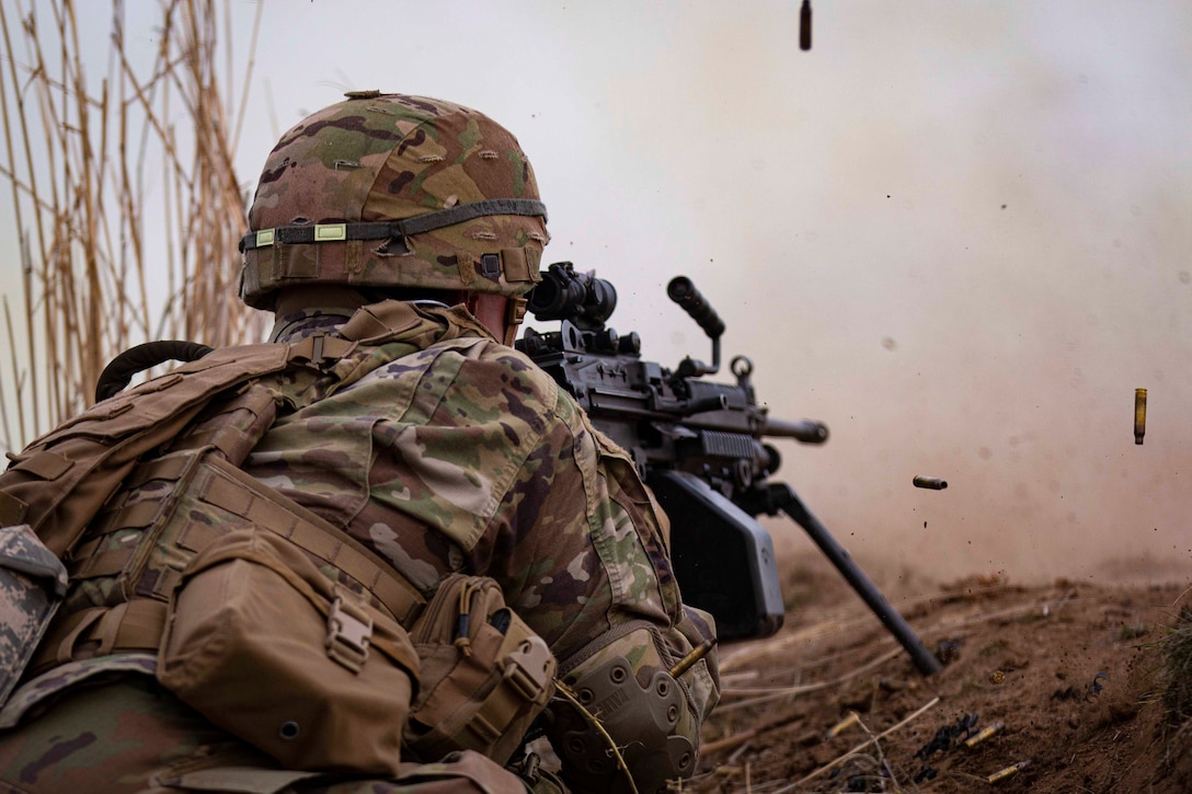 A soldier fires a weapon at a target.