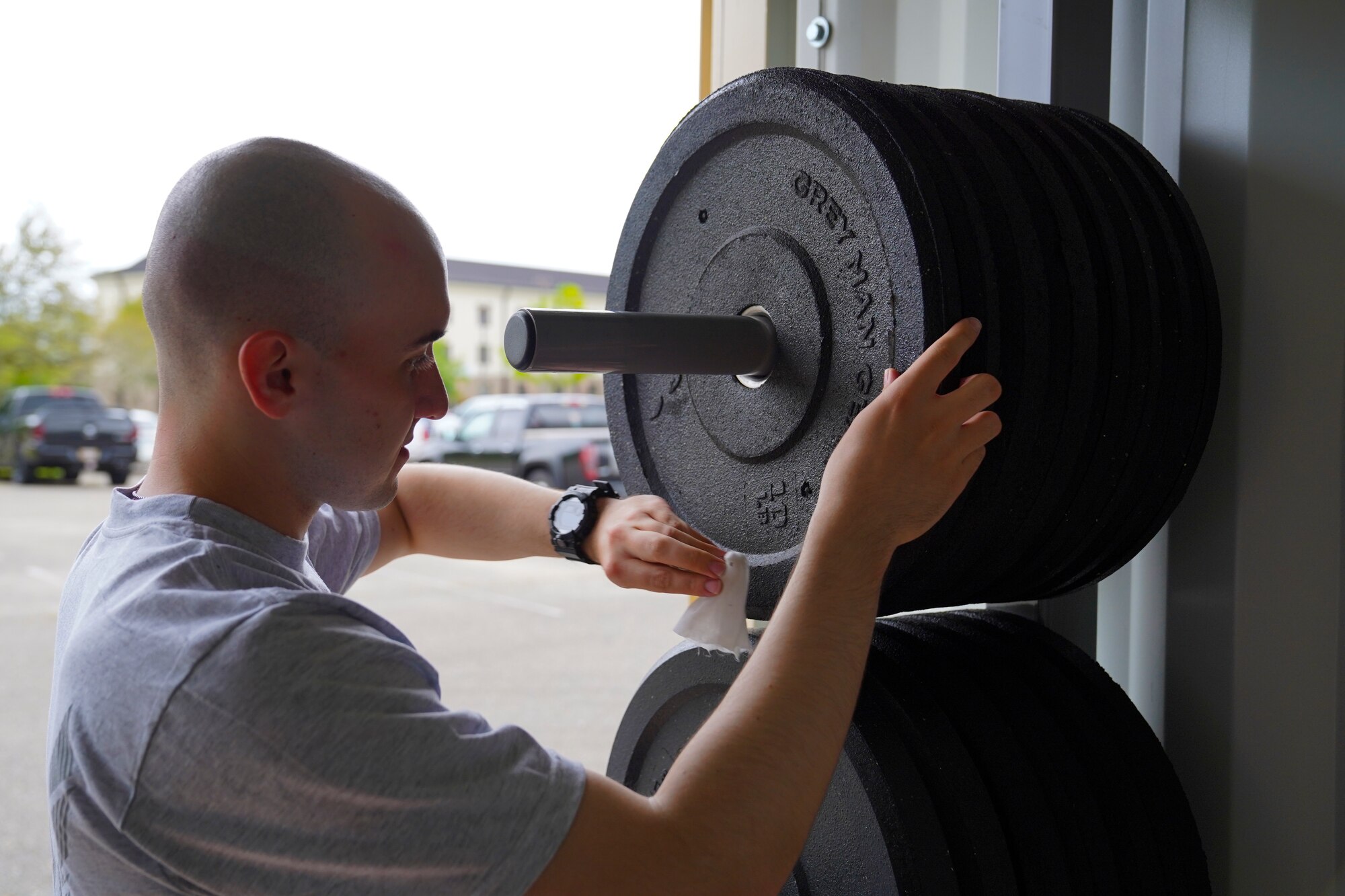 U.S. Air Force Airman Caleb Kovach, 336th Training Squadron client systems student, cleans equipment from a Beaver Fit Box at Keesler Air Force Base, Mississippi, April 10, 2021. The 81st Training Group acquired the Beaver Fit Boxes to provide more places for Airmen in training to work out while indoor gyms are operating at a limited capacity. (U.S. Air Force photo by Senior Airman Spencer Tobler)