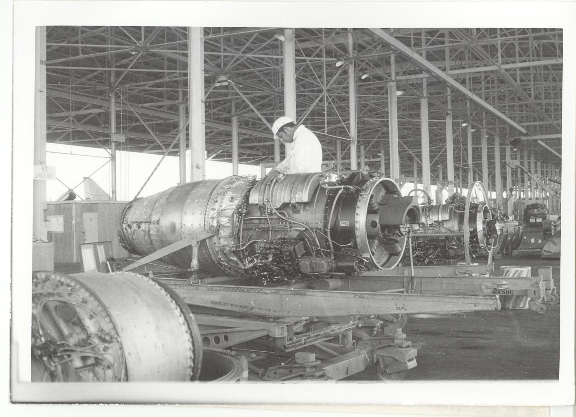 A photo of a service member working on a gas turbine.