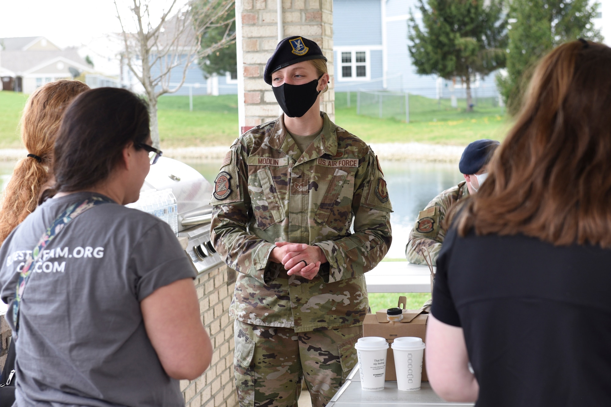 210409-F-AU145-1008 	Staff Sgt. Alyssa Modlin, noncommissioned officer in charge of police services for the 88th Security Forces Squadron, talks with Prairies residents during the “Coffee with a Cop” outreach April 9 at Wright-Patterson Air Force Base. The event allowed base housing residents to interact with Security Forces outside their regular patrol duties. (U.S. Air Force photo by Ty Greenlees)
