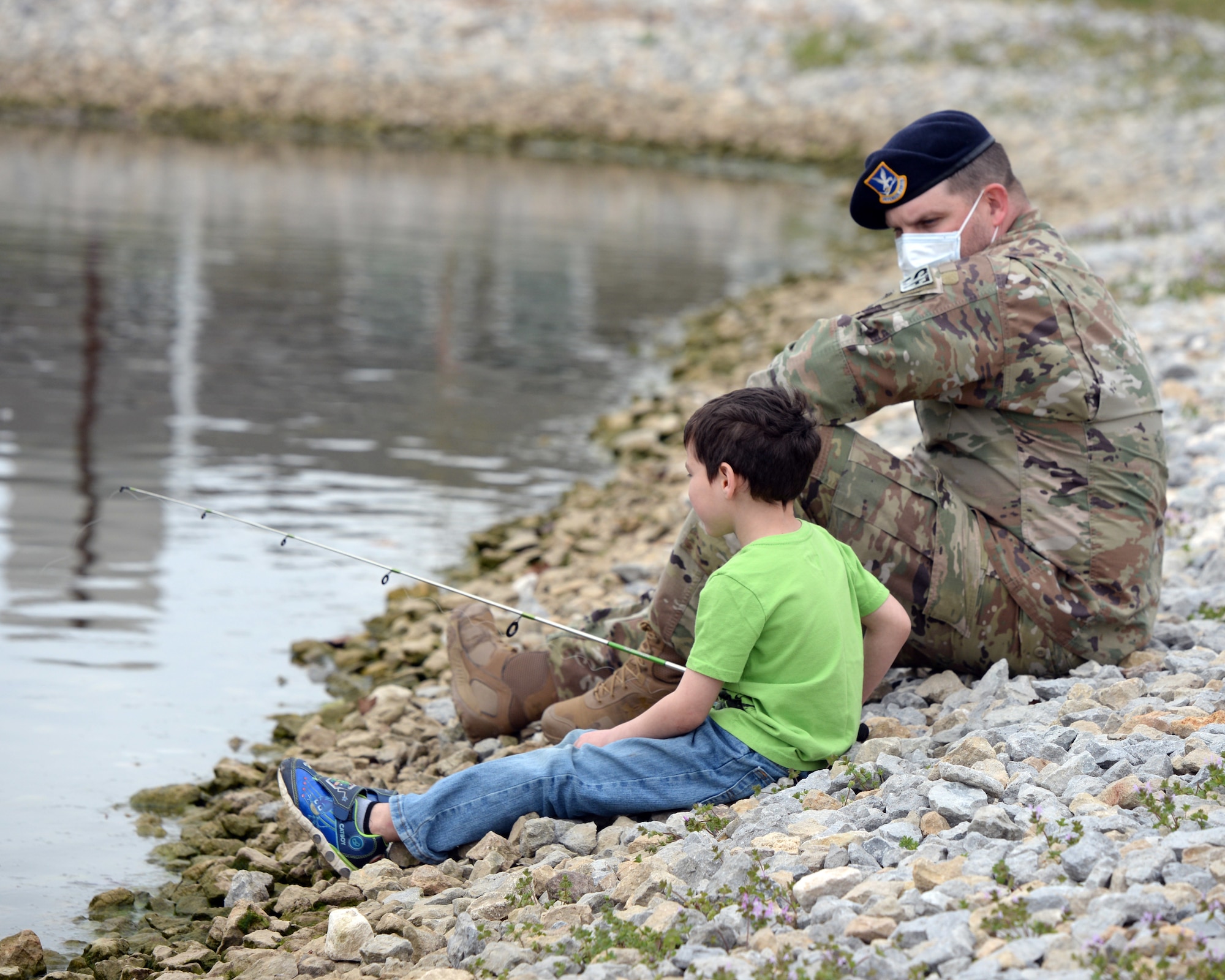 Tech. Sgt. Stephan Herrington, noncommissioned officer in charge of resource protection for the 88th Security Forces Squadron, goes fishing with Prairies resident Elijah Frutiger during the “Coffee with a Cop” outreach at Wright-Patterson Air Force Base on April 9. The event allowed base housing residents to interact with Security Forces outside their regular patrol duties. (U.S. Air Force photo by Ty Greenlees)