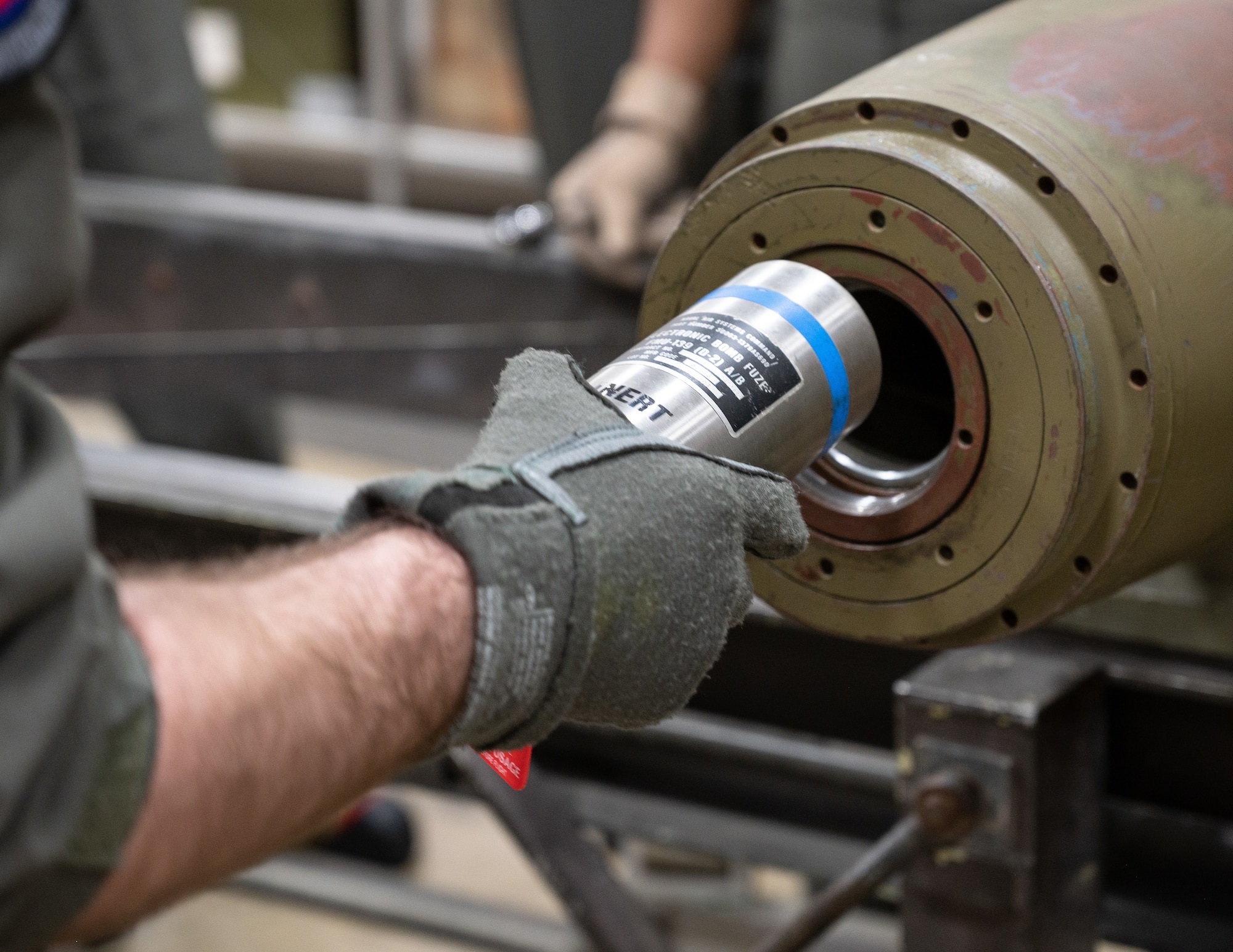 A student from the 340th Weapons Squadron weapons instructor training course inserts the fuse into an inert GBU-31 munition at Barksdale Air Force Base, Louisiana, April 13, 2021. Students demonstrated their knowledge of the assembly process using practice munitions. (U.S. Air Force photo by Airman William Pugh)
