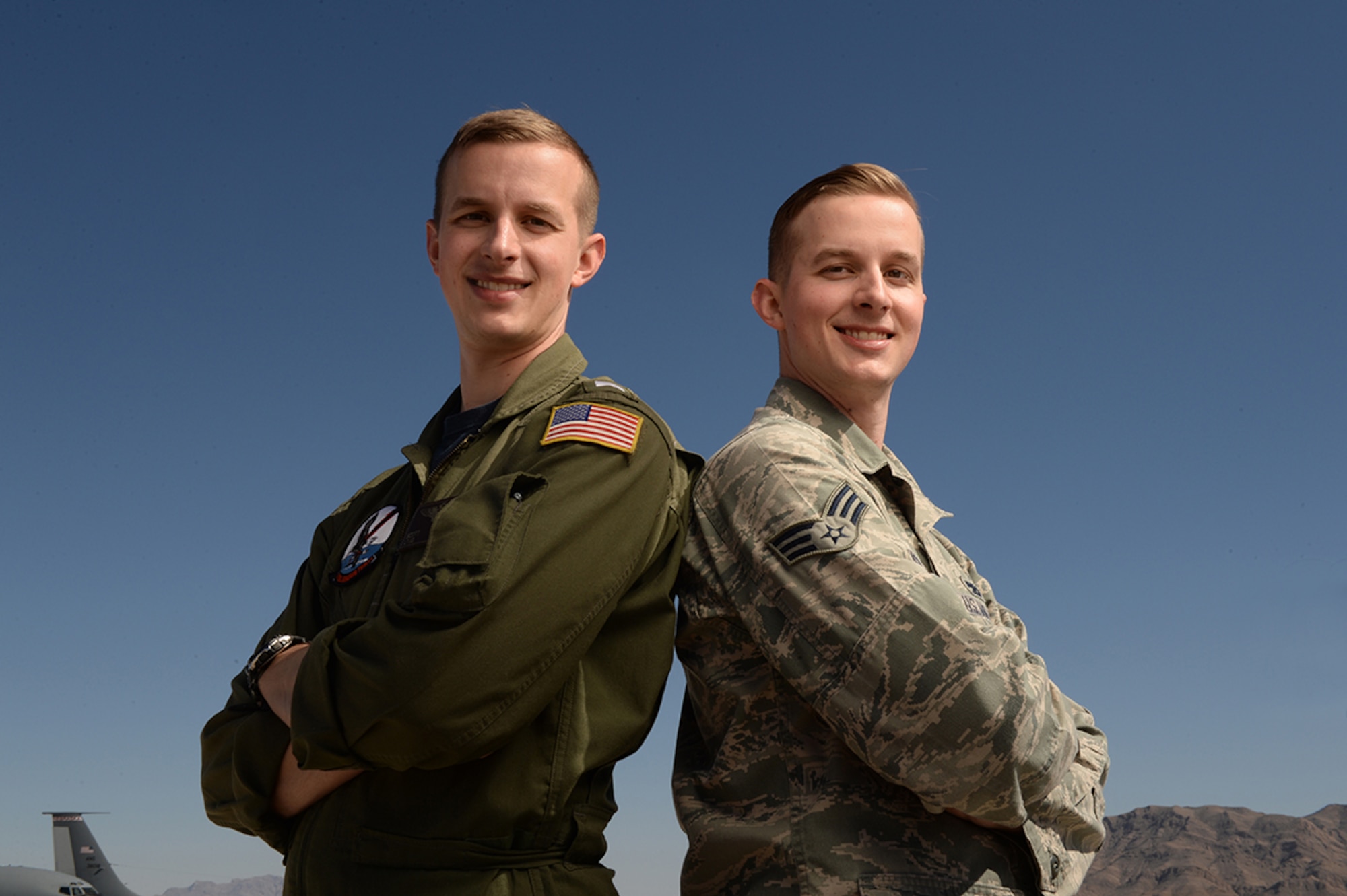 U.S. Navy LTJG Scott Russell and U.S. Air Force Senior Airman Brian Russell, reunite in uniform during Red Flag 15-2 at Nellis Air Force Base, Nevada, March 7, 2015. Brian is a KC-135 Stratotanker crew chief with the 22nd Maintenance Squadron at McConnell Air Force Base, Kansas, while Scott is a Navy Lieutenant junior grade and an EP-3E Aeries pilot with the Fleet Air Reconnaissance Squadron One at Naval Air Station Whidbey Island, Washington. (U.S. Air Force photo by/Staff Sgt. Vernon Young Jr.)