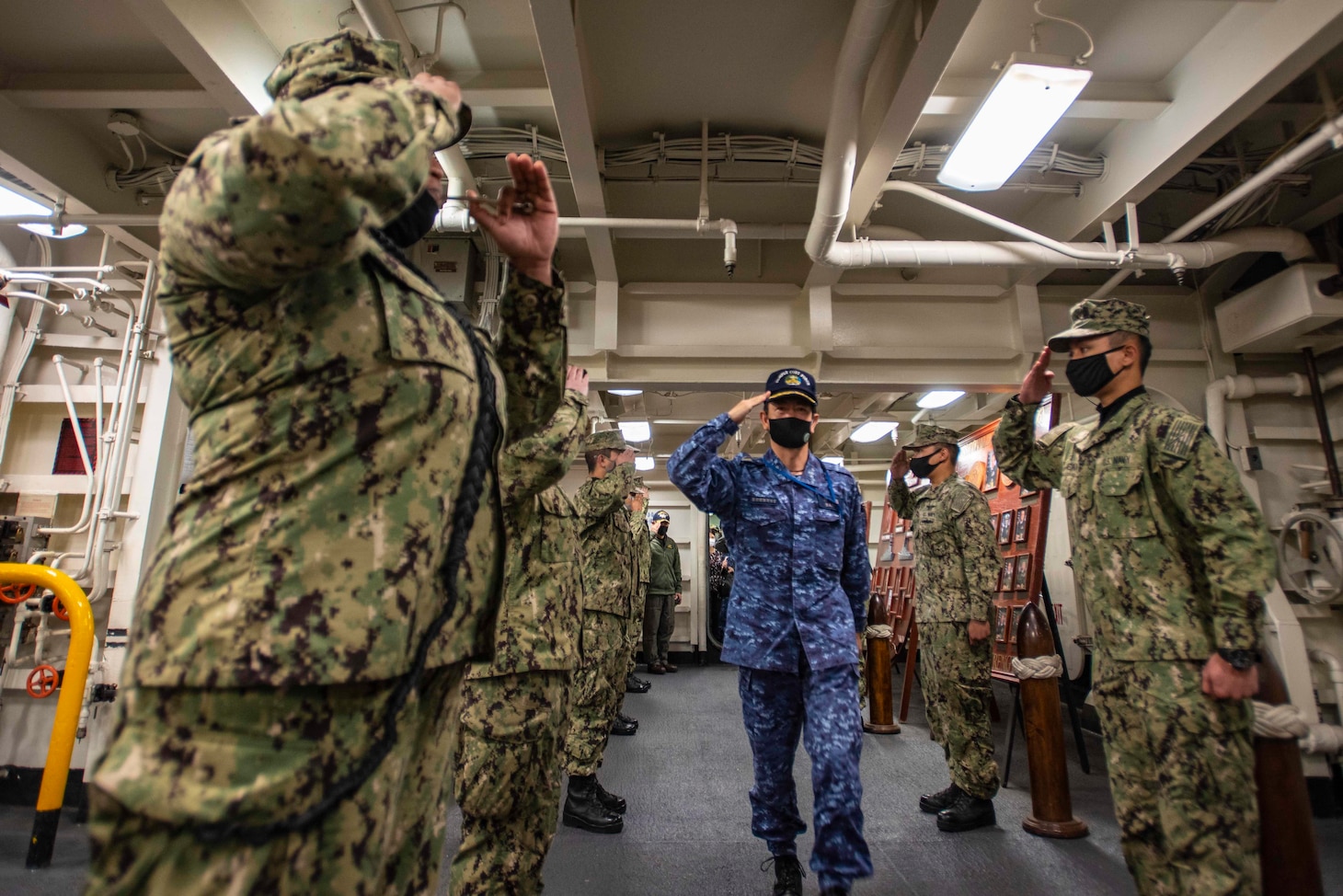 210415-N-WS494-1036 YOKOSUKA, Japan (April 15, 2021) Vice Adm. SAITO Akira, commander of Japan Maritime Self-Defense Force (JMSDF) Fleet Escort Force, salutes sideboys on the ceremonial quarterdeck of the U.S. Navy’s only forward-deployed aircraft carrier, USS Ronald Reagan (CVN 76). Leadership from Carrier Strike Group (CSG) 5 and Destroyer Squadron (DESRON) 15 met with the commander of JMSDF Fleet Escort Force aboard Ronald Reagan for a ship tour and staff discussions. Ronald Reagan, the flagship of Carrier Strike Group 5, provides a combat-ready force that protects and defends the United States, as well as the collective maritime interests of its allies and partners in the Indo-Pacific region. (U.S. Navy Photo by Mass Communication Specialist 3rd Class Quinton A. Lee)