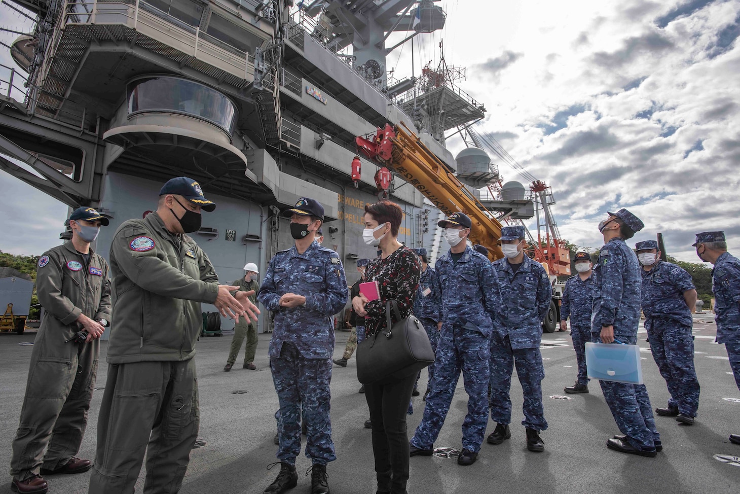 210415-N-WS494-1135 YOKOSUKA, Japan (April 15, 2021) Vice Adm. SAITO Akira, commander of Japan Maritime Self-Defense Force (JMSDF) Fleet Escort Force, and staff members, receive a tour of the flight deck from Capt. Fred Goldhammer, commanding officer, on the U.S. Navy’s only forward deployed aircraft carrier USS Ronald Reagan (CVN 76). Leadership from the 7th Fleet task forces that command Carrier Strike Group (CSG) 5 and Task Force 71 met with the commander of Japan Maritime Self-Defense Force (JMSDF) Fleet Escort Force aboard Ronald Reagan for a ship tour and staff discussions. Ronald Reagan, the flagship of CSG 5, provides a combat-ready force that protects and defends the United States, as well as the collective maritime interests of its allies and partners in the Indo-Pacific region. (U.S. Navy Photo by Mass Communication Specialist 3rd Class Quinton A. Lee)