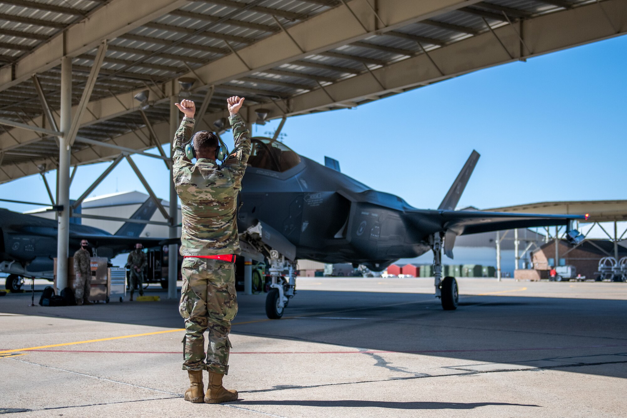 Senior Airman Thomas Rich, a crew chief in the 419th Aircraft Maintenance Squadron, signals to an F-35A Lightning II pilot during launch procedures April 10 at Hill Air Force Base, Utah.