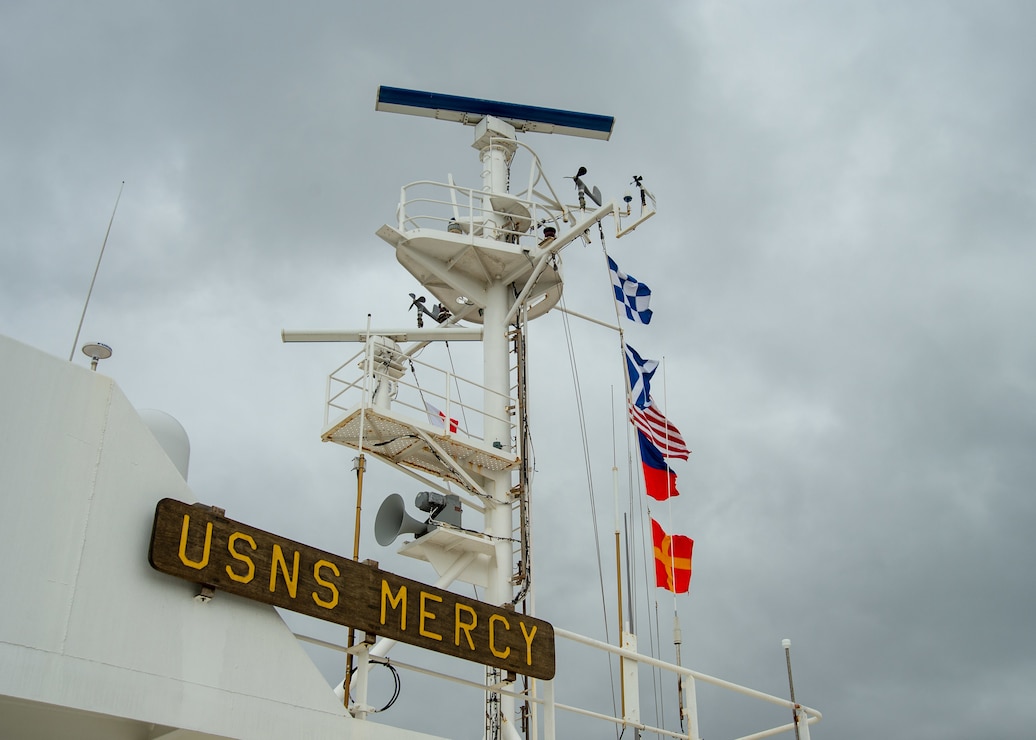 A photo of the mast of the Military Sealift Command hospital ship USNS Mercy (T-AH 19) with underway pennants.